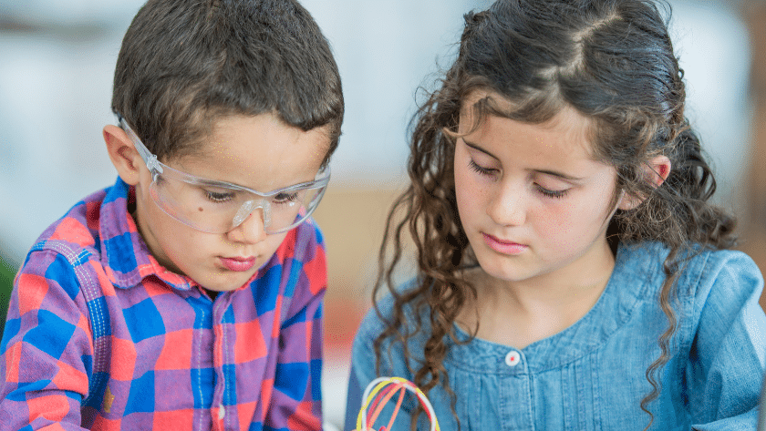 Two students working together on a classroom activity, showing focus and cooperation within a supportive classroom community