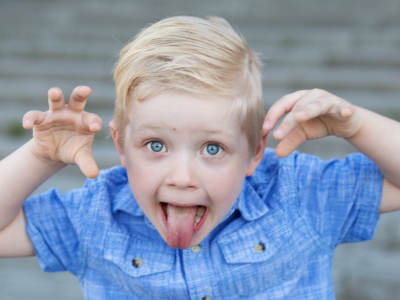 young boy making a silly face demonstrating how children test boundaries when classroom expectations are unclear