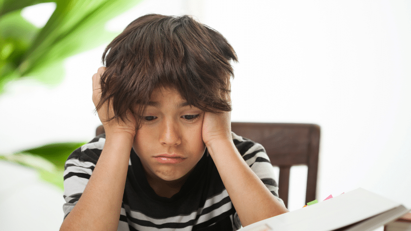 Boy head in hands demonstrating learned helplessness in students